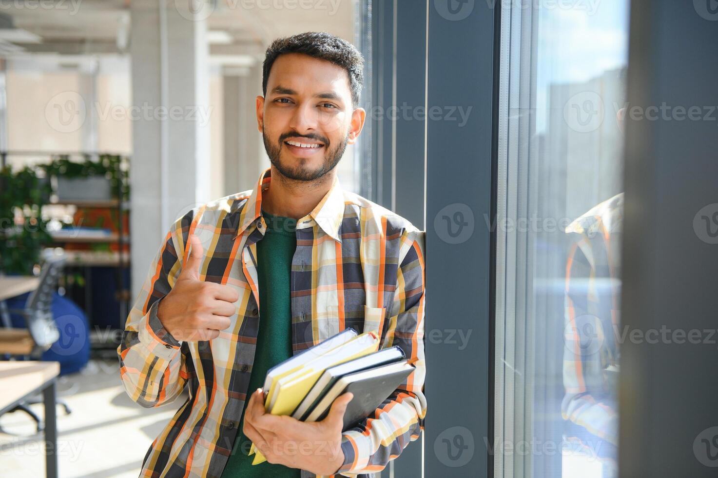 Happy indian male student at the university photo