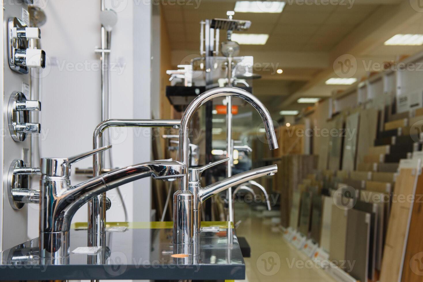 Rows of new faucets in plumbing shop, closeup photo