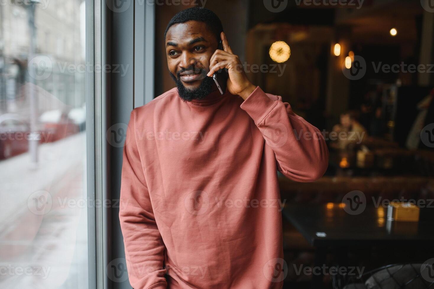 mature african american man talking by phone in cafe. photo