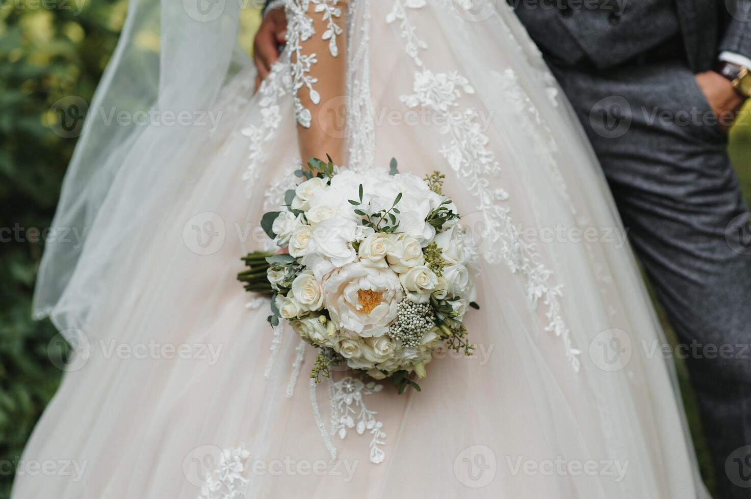 Bride holding big wedding bouquet on wedding ceremony photo