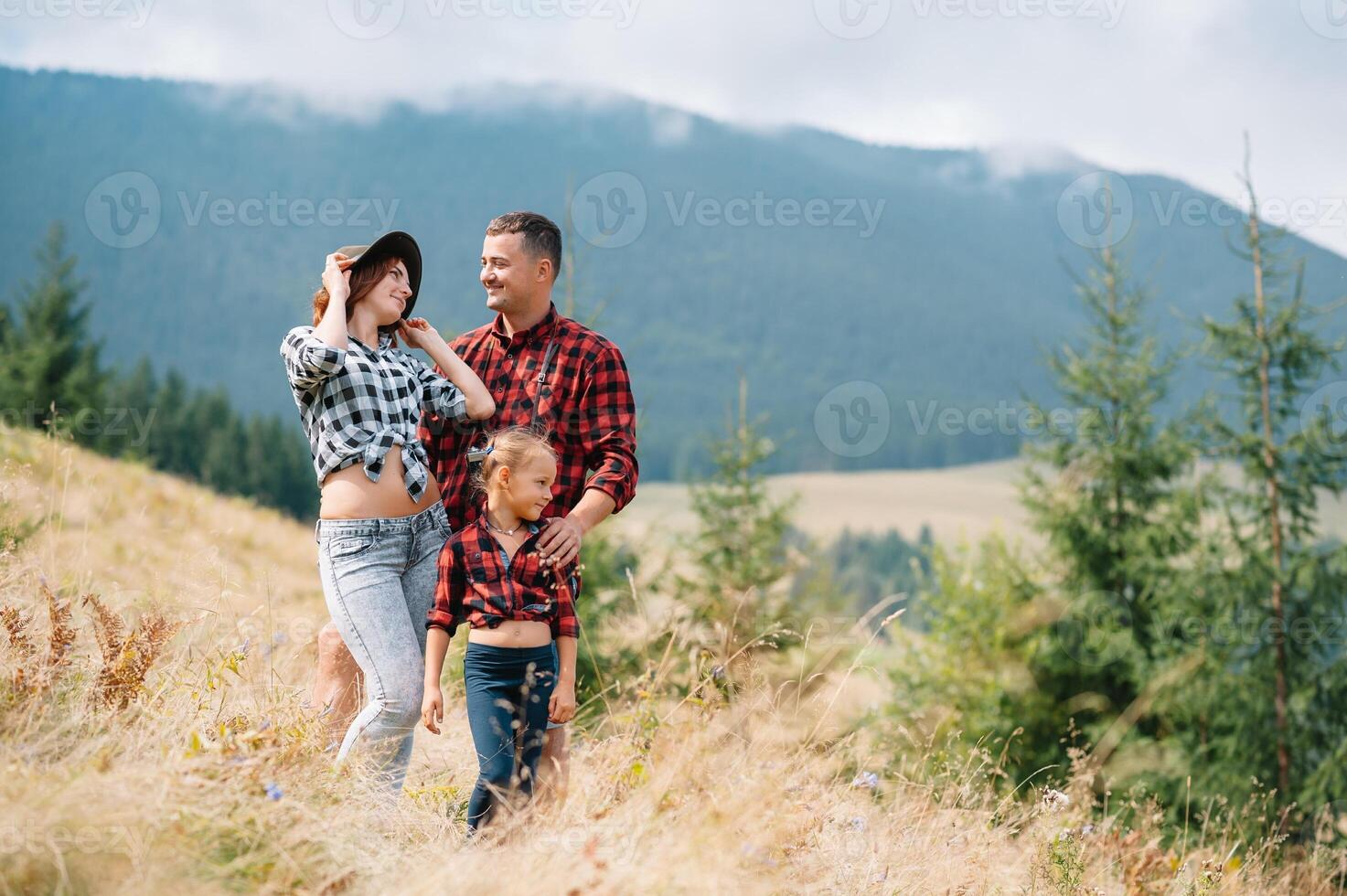 Young family with child resting on a mountain. vacation in the national park photo