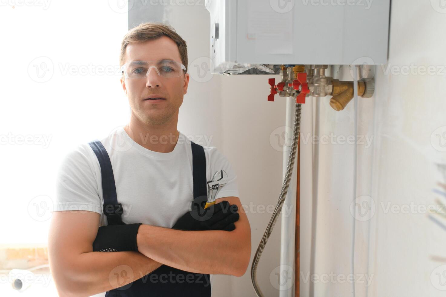 Professional boiler service qualified technician checking a natural gas boiler at home photo