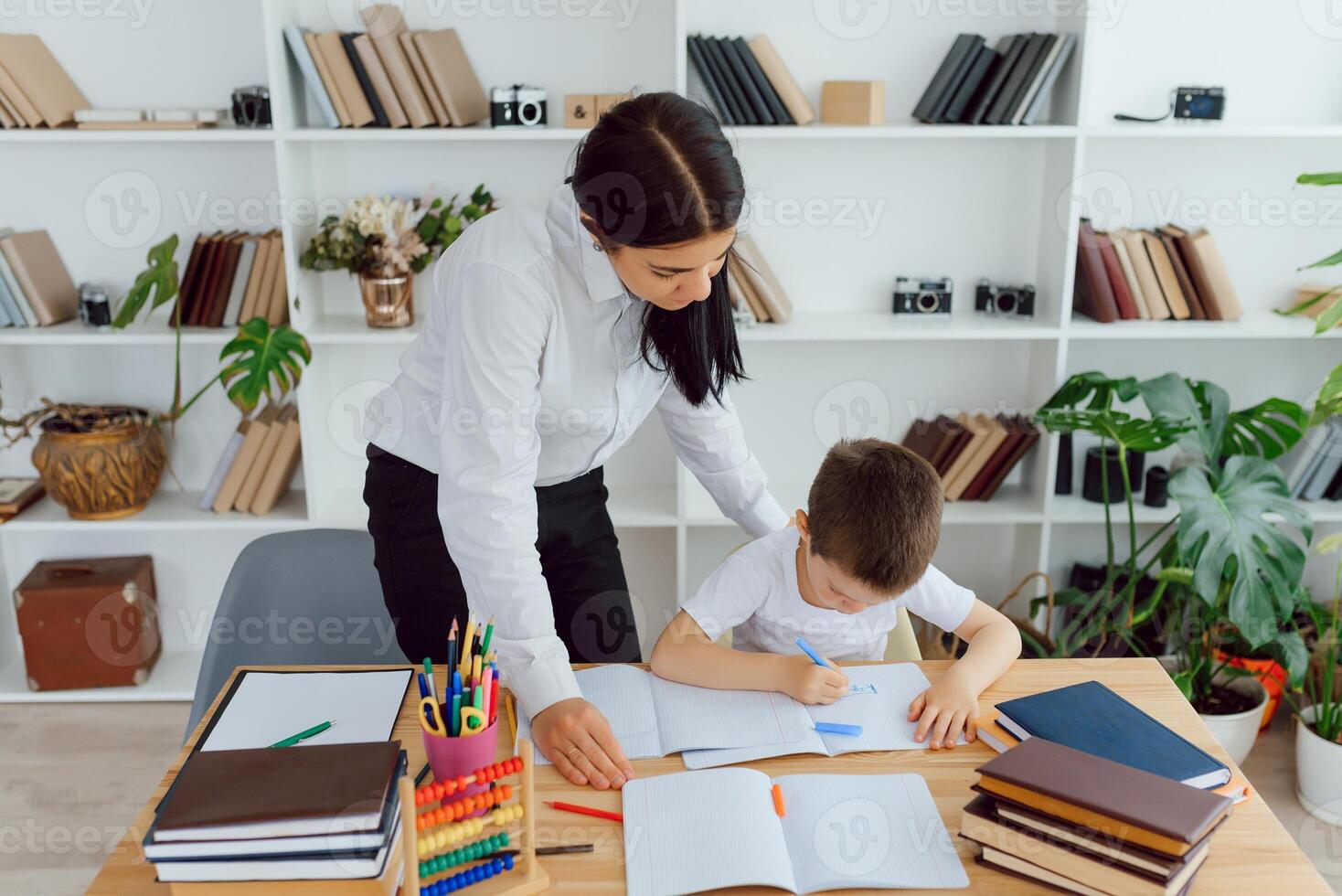 Tutor with pupil. Little girl studying. Private lesson. photo