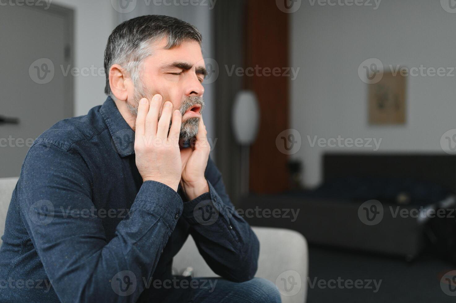 Headache. Senior Man Suffering From Migraine Pain Massaging Temples Sitting At Home. Healthcare, Health Problems In Older Age Concept photo