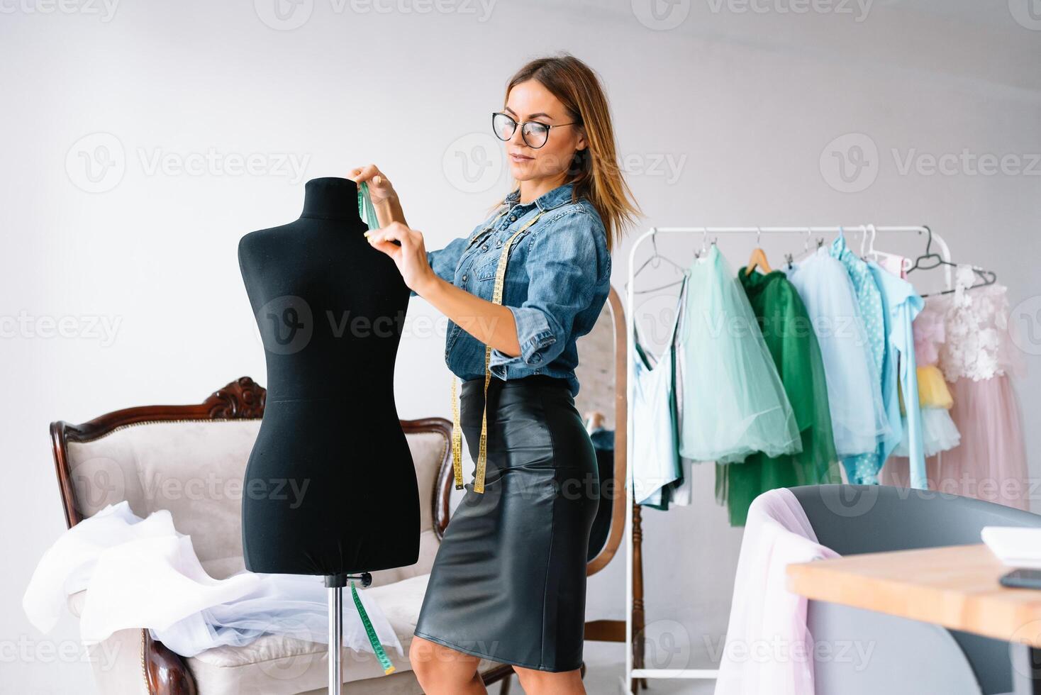 Can't make any mistake. Female fashion designer works on the new clothes in the workshop photo