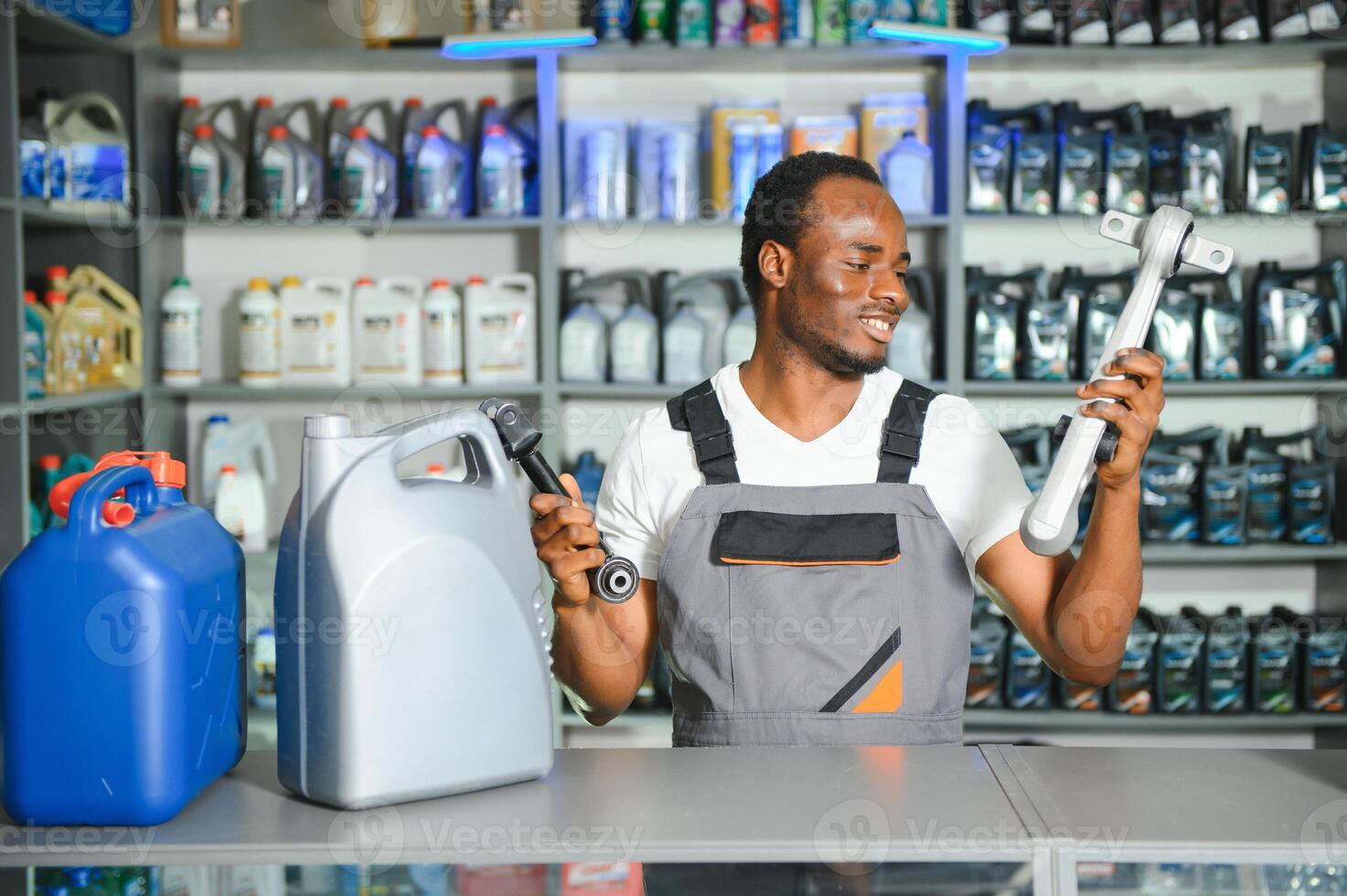 Portrait of a handsome african salesman in an auto parts store. The concept of car repair photo