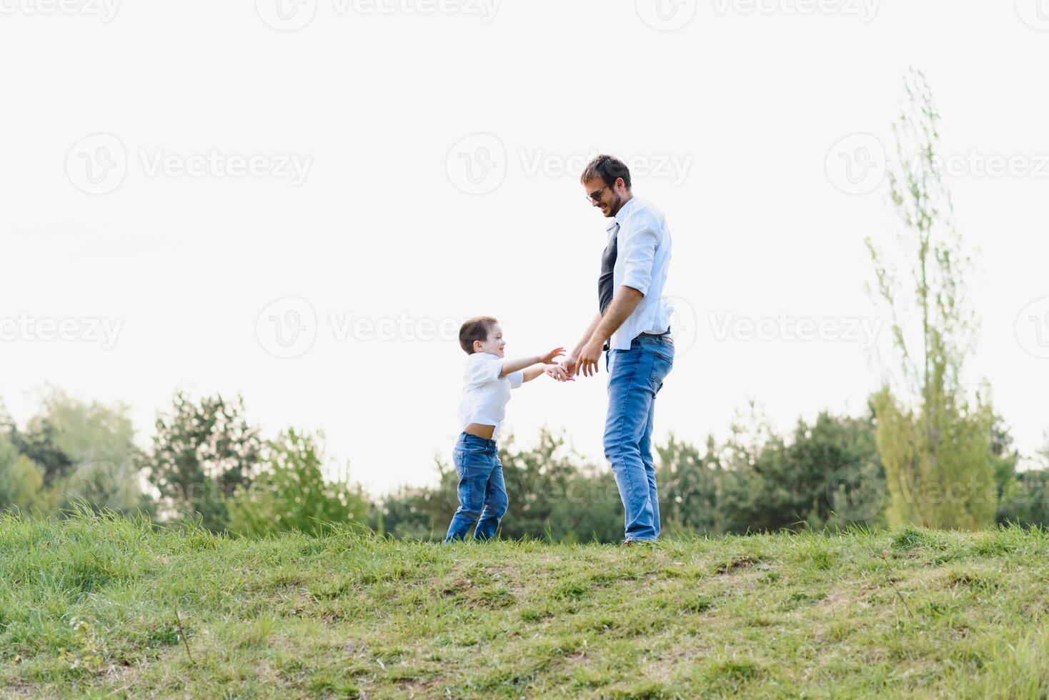 Happy time with father. Family fun concept. Bearded man and cute son Kids smile. Spring time walk with father. photo