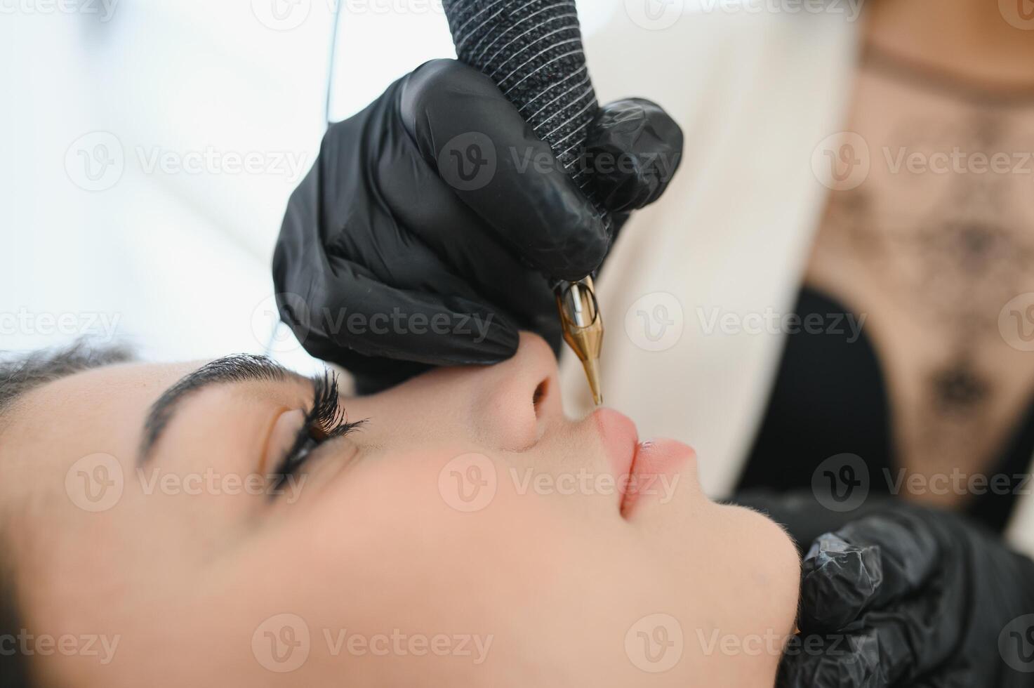 Healthy Spa, Young Beautiful Woman Having Permanent Make-up on her Lips. Close-up photo