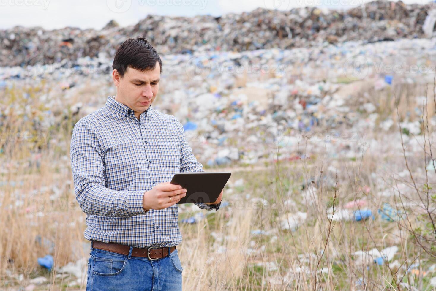 Nature conservation concept. A man studies the pollution of nature. Keeping the environment clean. Ecological problems. Recycling photo