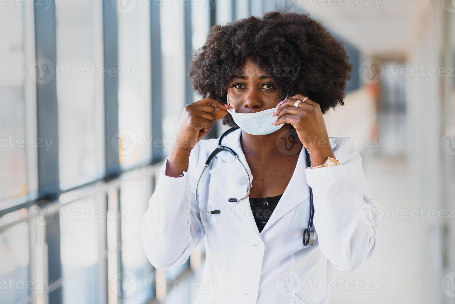 Young attractive african doctor with face mask photo