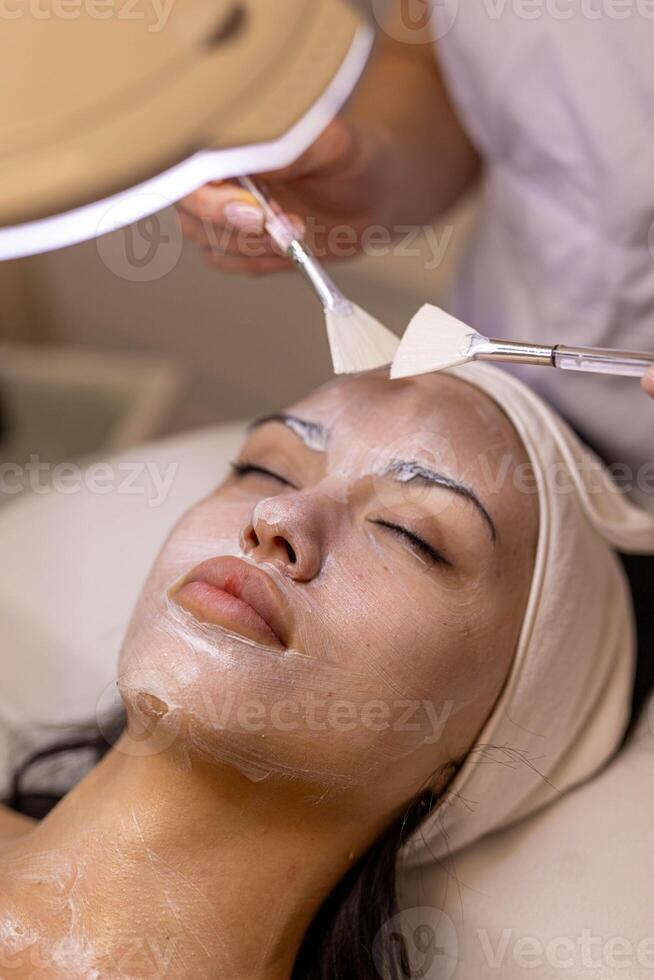 woman at the cosmetologist. She has problem skin and acne. photo