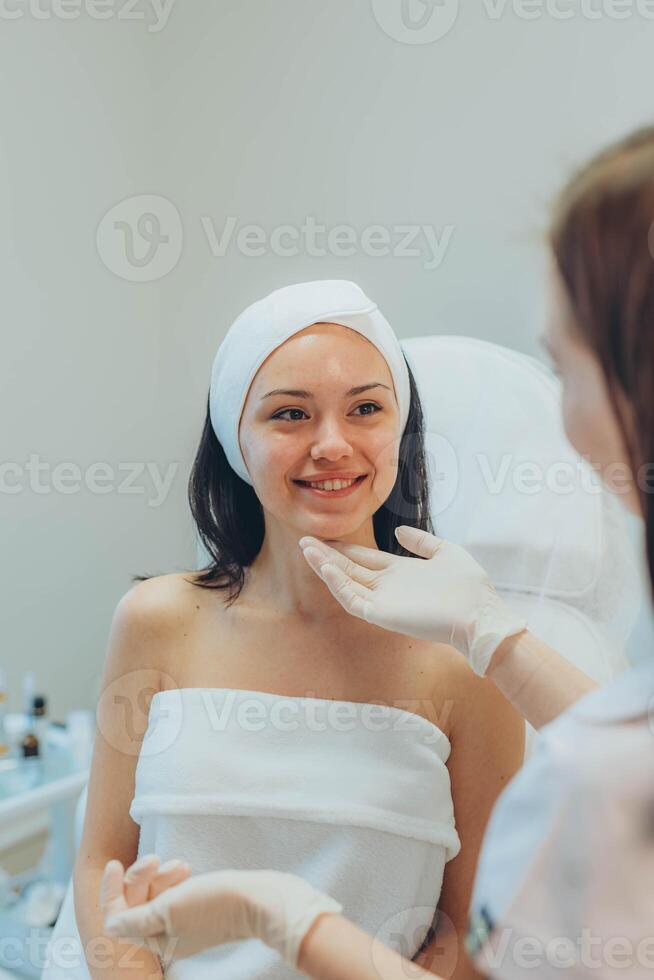 girl at a cosmetologist's office doing skin cleansing photo