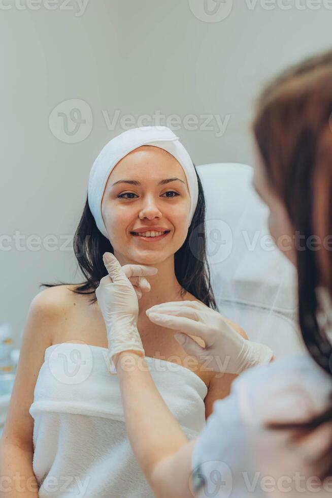 girl at a cosmetologist's office doing skin cleansing photo