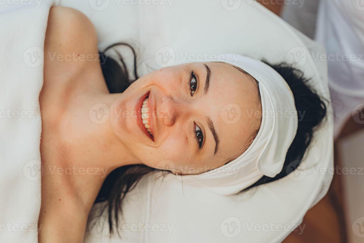 girl at a cosmetologist's office doing skin cleansing photo