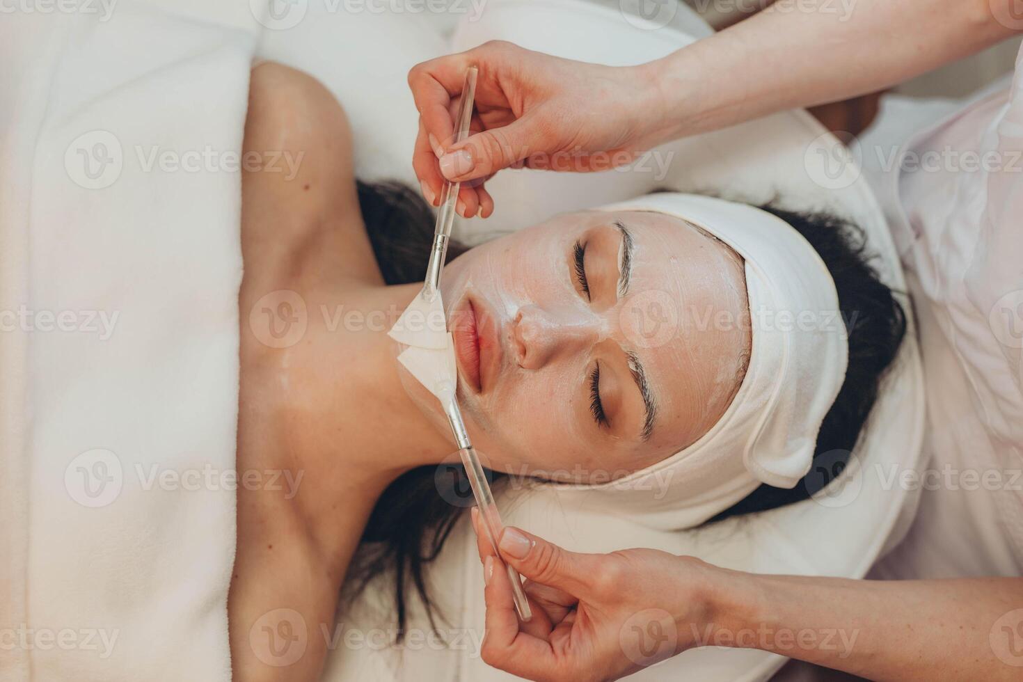 woman at the cosmetologist. She has problem skin and acne. photo