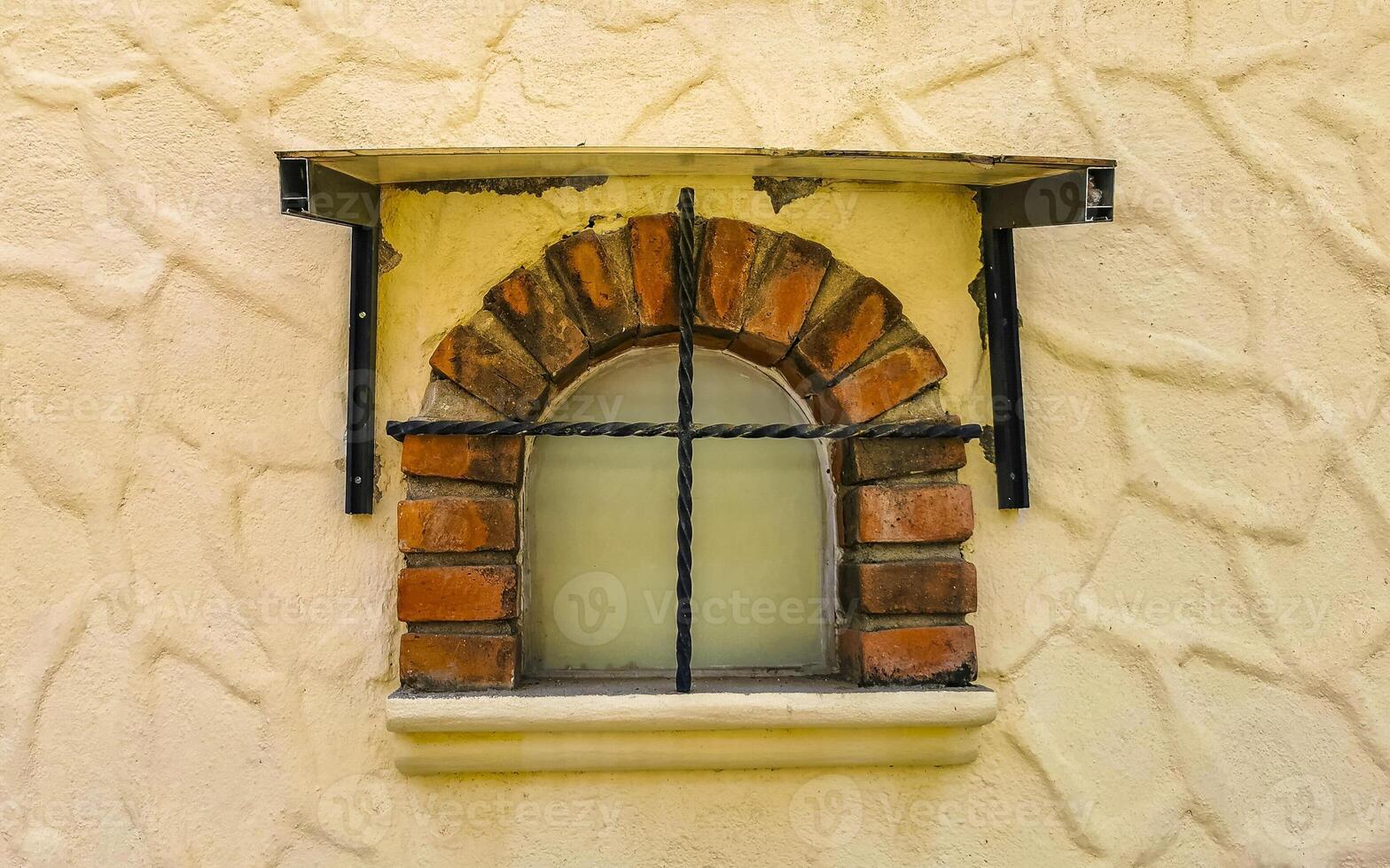 Old small window on cement wall Concrete walls Mexico. photo