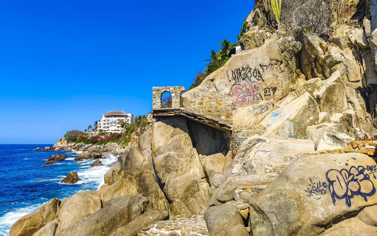 Puerto Escondido Oaxaca Mexico 2023 Beautiful rocks cliffs view waves at beach coast panorama Mexico. photo