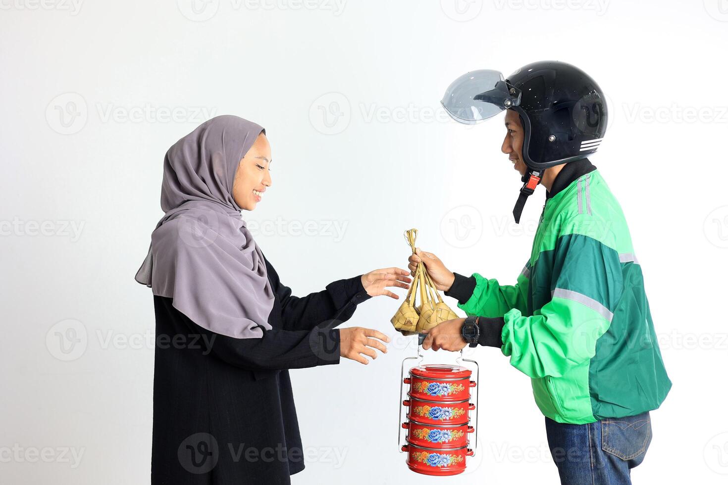 Commercial Online Taxi Driver Delivery Ketupat and Side Dish on Traditional Indonesian Lunchbox photo