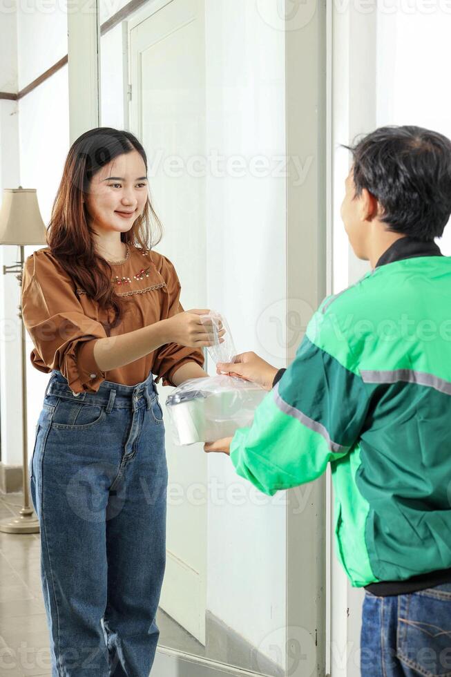 Online Driver Delivering Coffee and Food to Female Customer photo