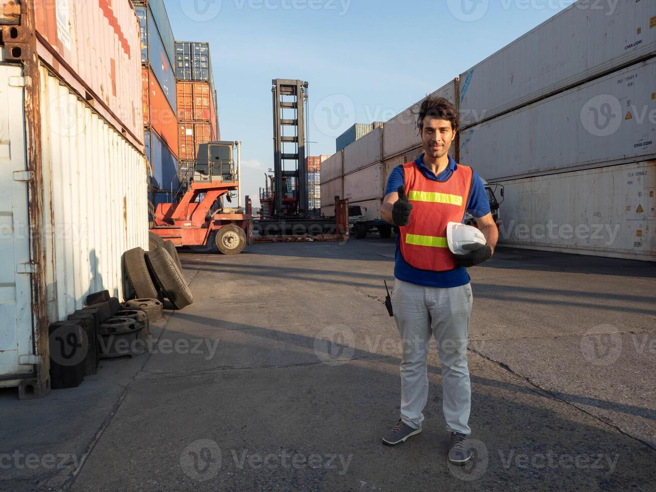 Labor man male person people human look at camera manager white hardhat safety helmet cheerful thumb up pointing finger container import export logistic cargo industry labor day factory professional photo