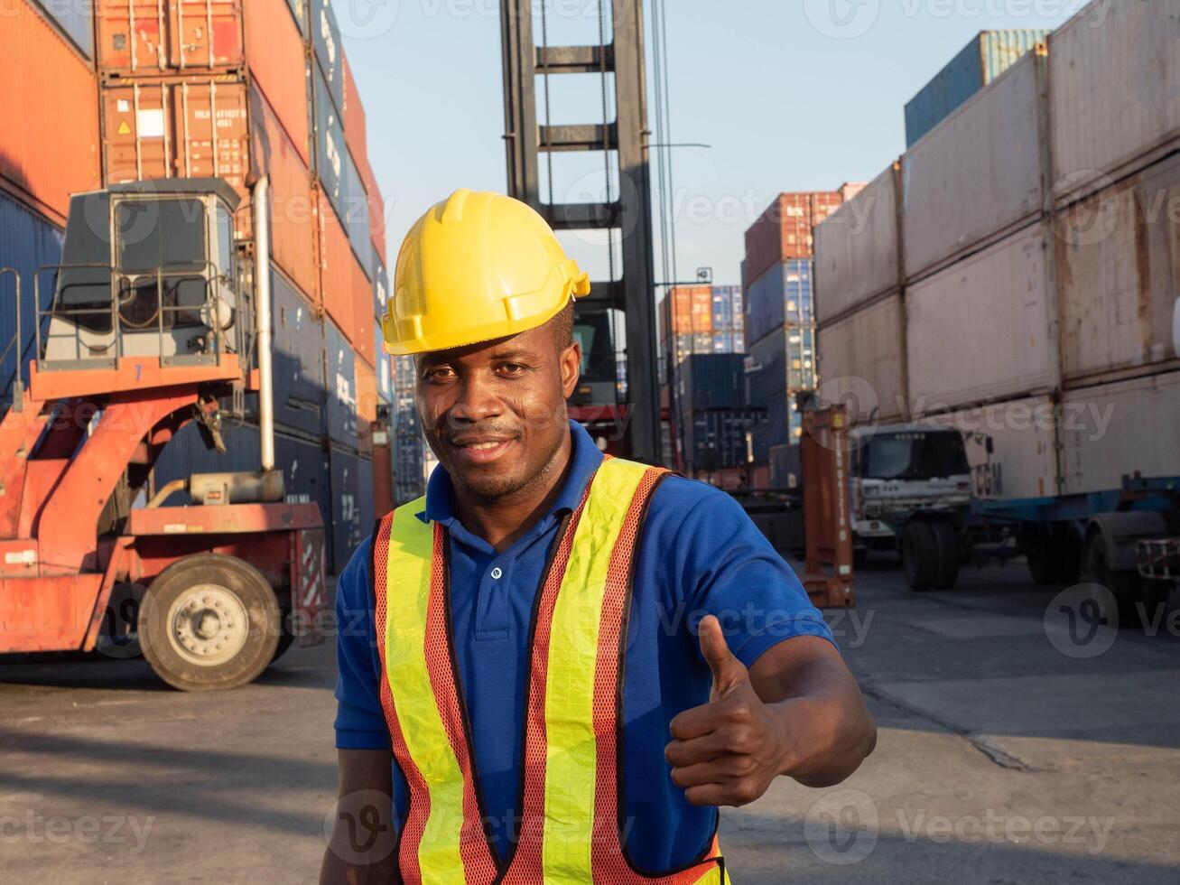 Male man black skin south african safety helmet yellow hardhat cheerful thumb up pointing finger employee engineer foreman labor day factory import export construction cargo logistic forklift builder photo