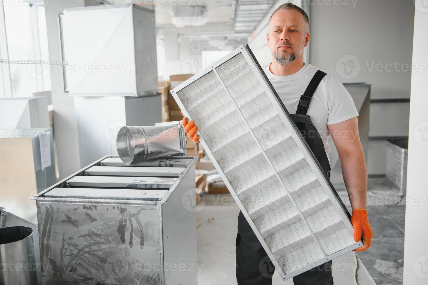 Worker holding air filter for installing in the office ventilation system. Purity of the air concept. photo