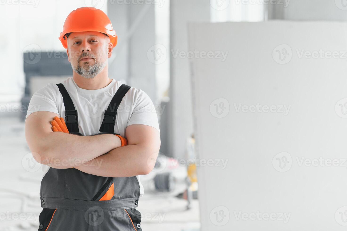 Man Builder. Architect is standing in building. Portrait of thinking builder. Builder architect in unfinished building. Architect in working uniform. photo
