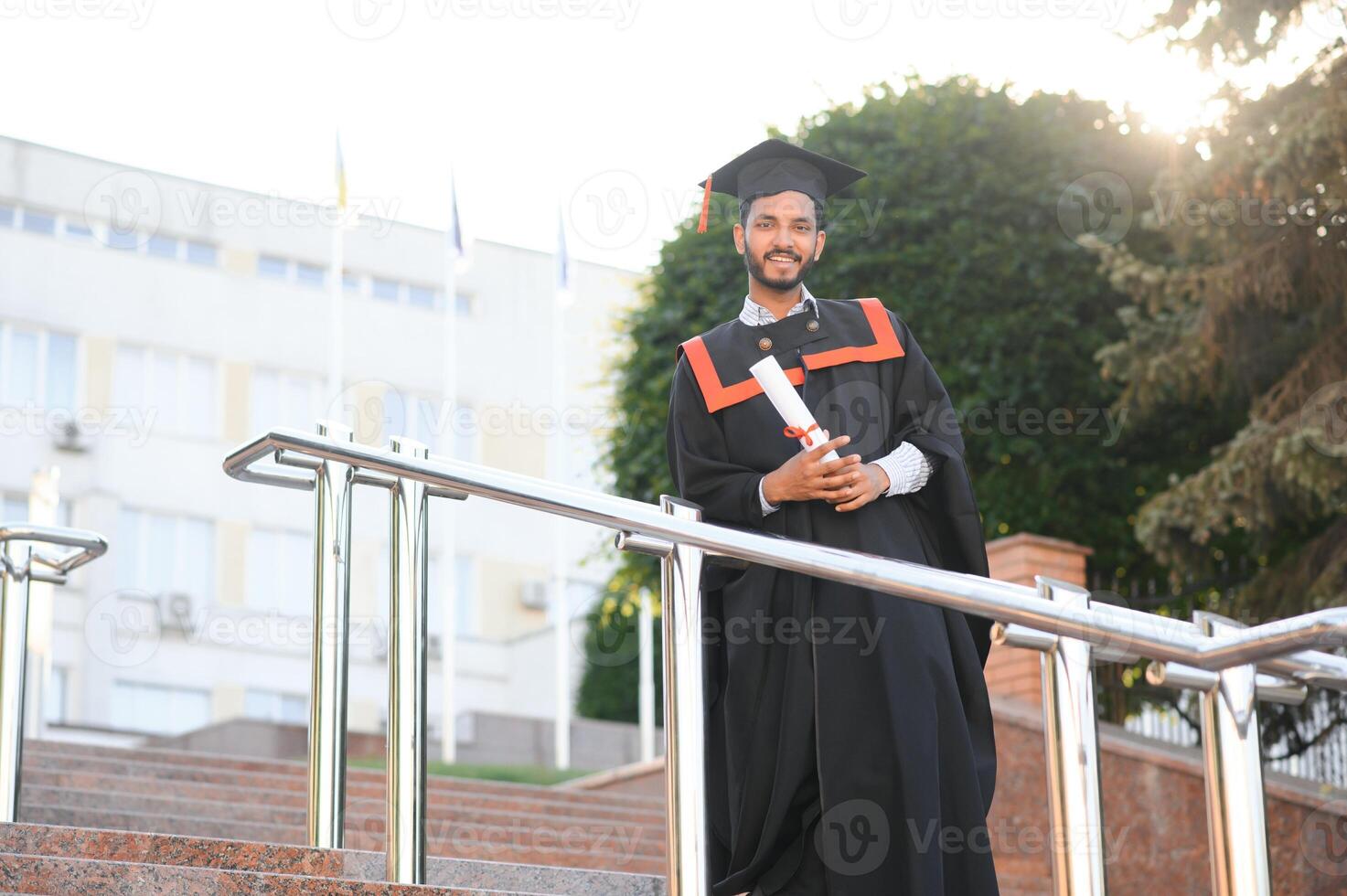 education, graduation and people concept - happy Indian Male graduate student. photo