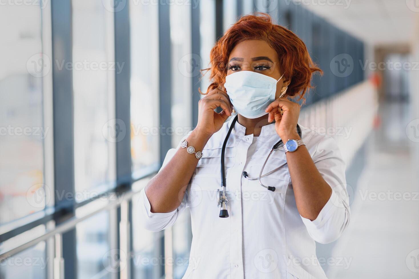 Young attractive african doctor with face mask photo