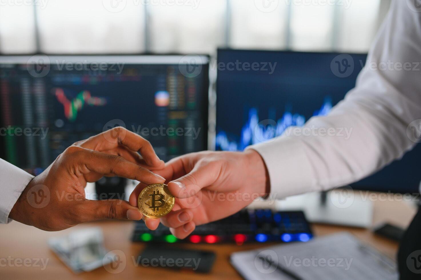View of hand holding a bitcoin and giving it to other people. Cryptocurrency trading concept photo