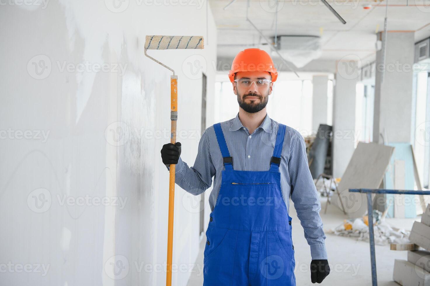 painter man painting the wall, with paint roller photo