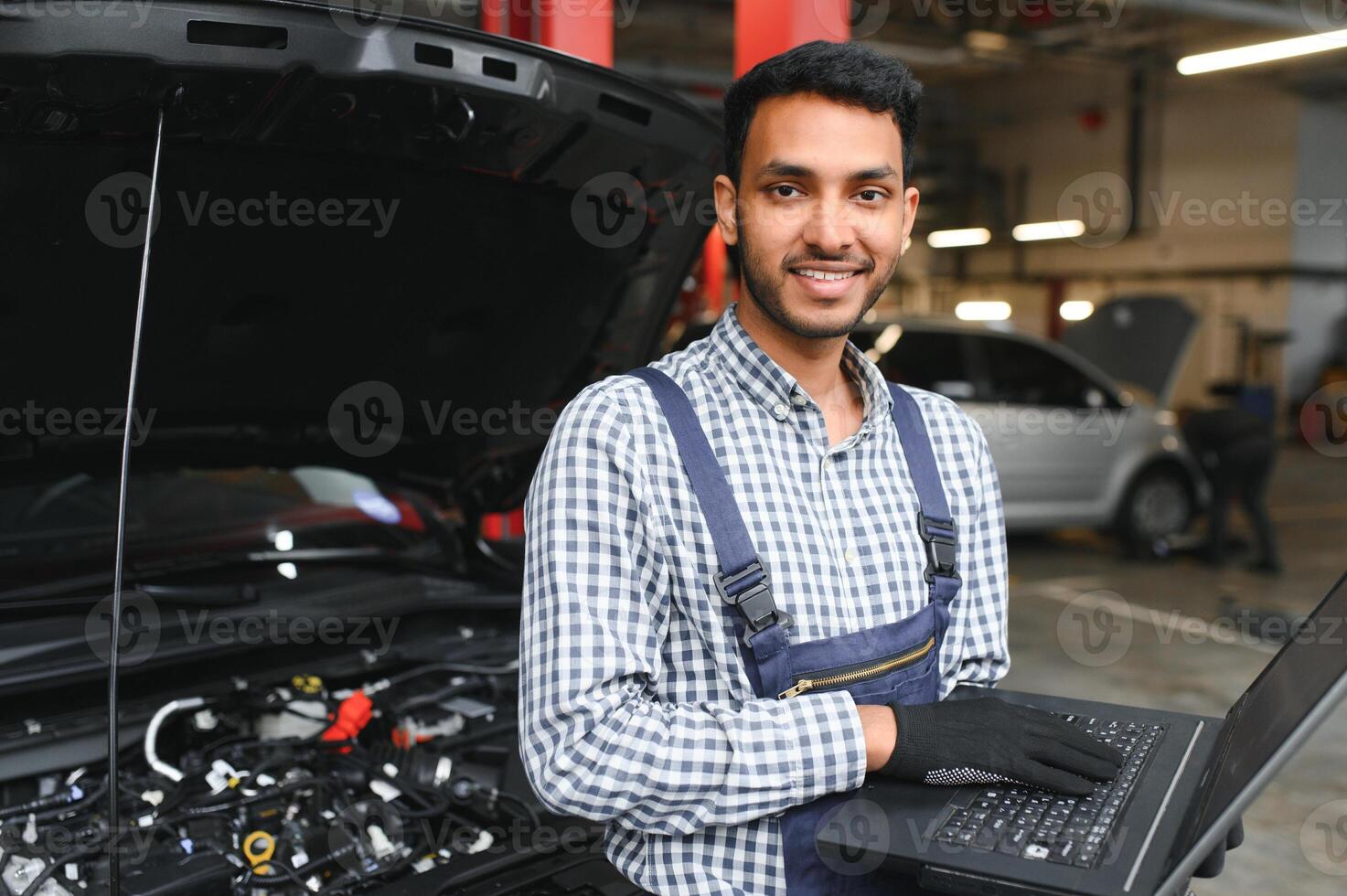Handsome Indian Auto Mechanic at car servise photo