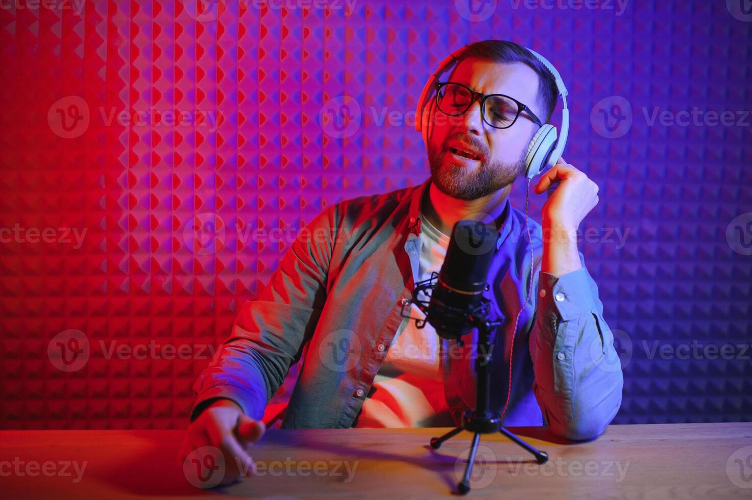 A video blogger records content in his studio. The backstage photo was taken from behind one of the participants in the shooting, at the beginning of the shooting when the blogger is preparing.