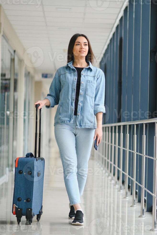 Pretty young female passenger at the airport photo