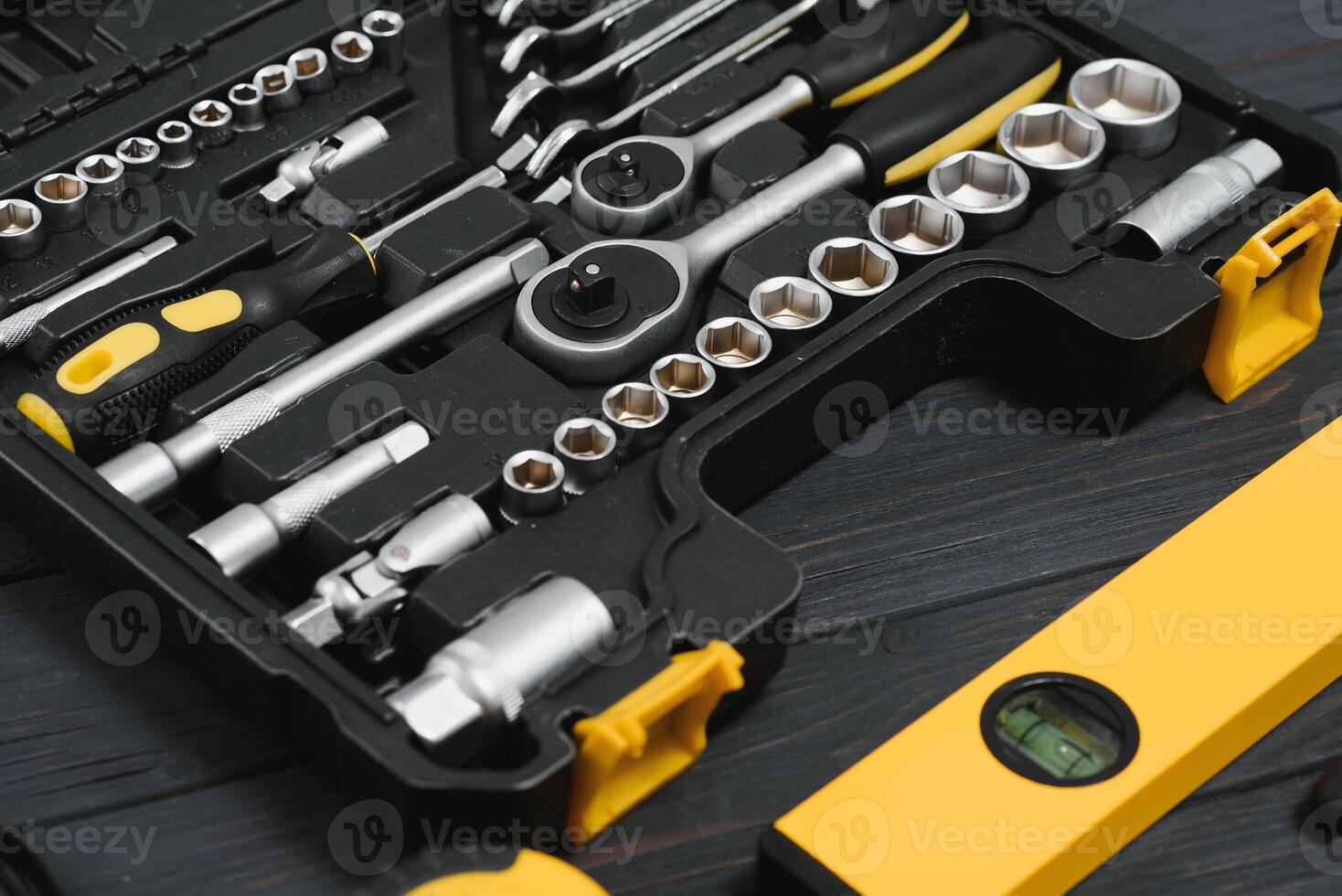 New square black tool box on wooden texture background. Top view. photo