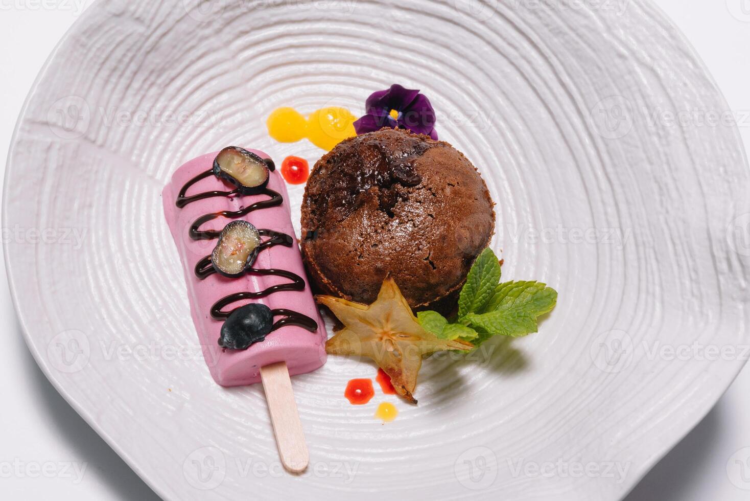 Chocolate fondant with vanilla ice cream and raspberry sauce photo