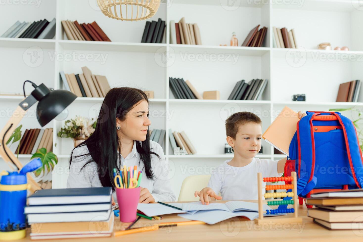 Tutor with pupil. Little boy studying. Private lesson. The concept of private lessons and homework. photo