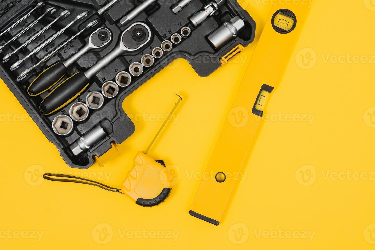 Set of various construction tools. Tools for home repair. Work at a construction site. On a yellow background. Flatly. Flatlay photo