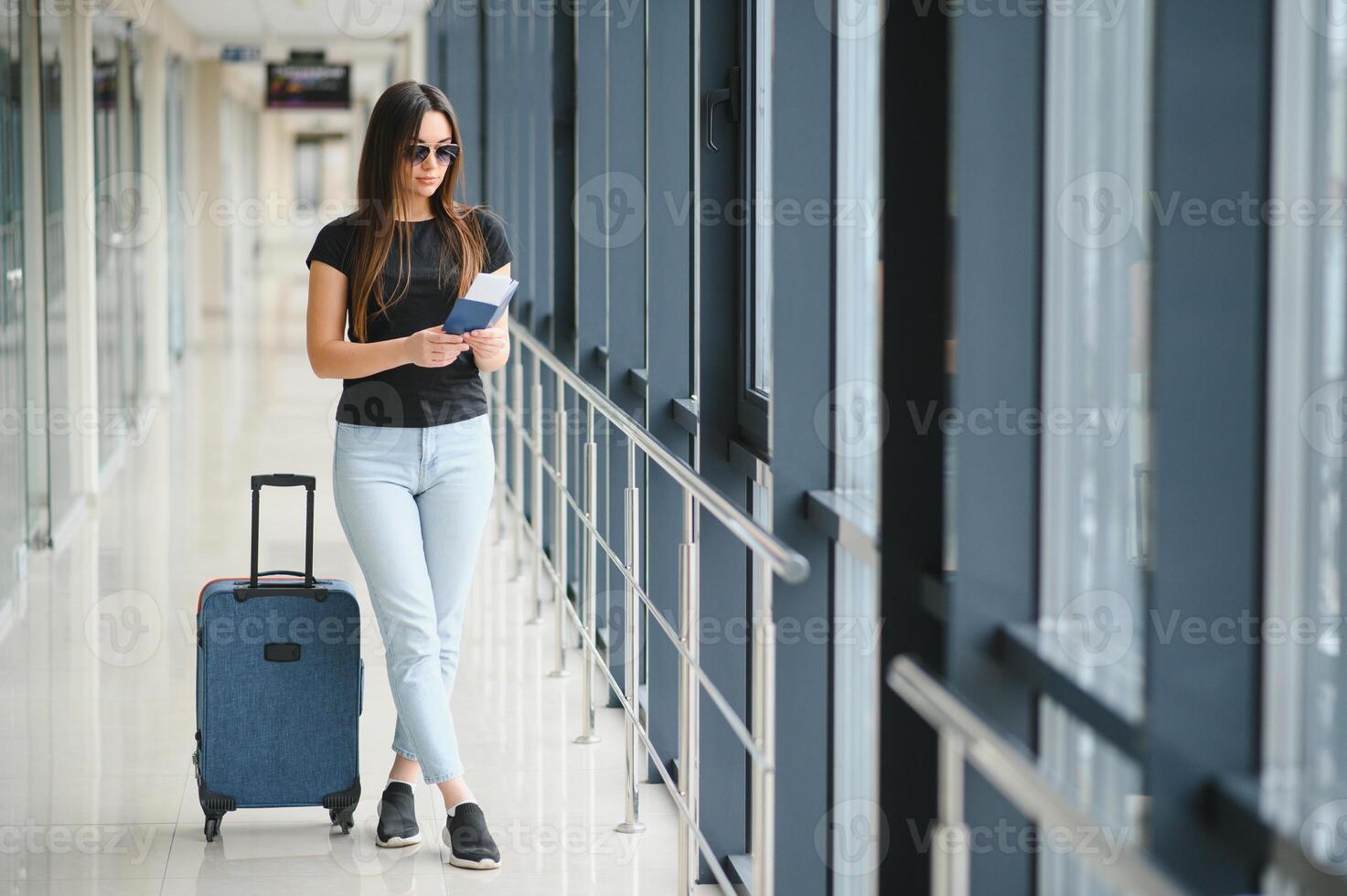 tourism, holiday, vacation, childhood and transportation concept - smiling little girl with travel bag over airport background photo