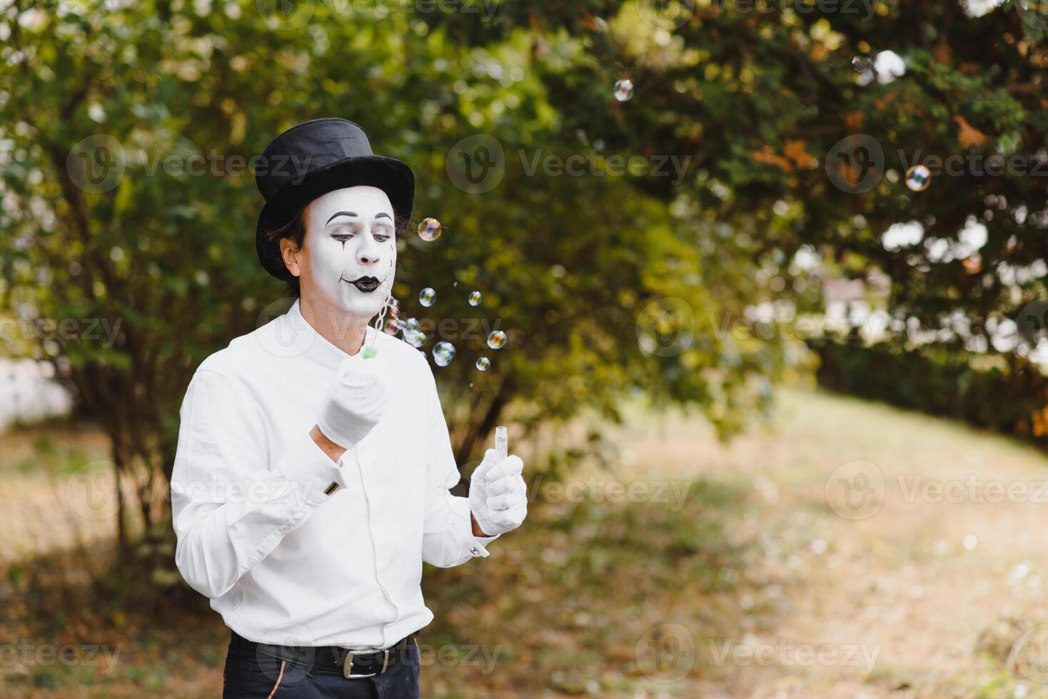 Mime artist blowing a bubble photo