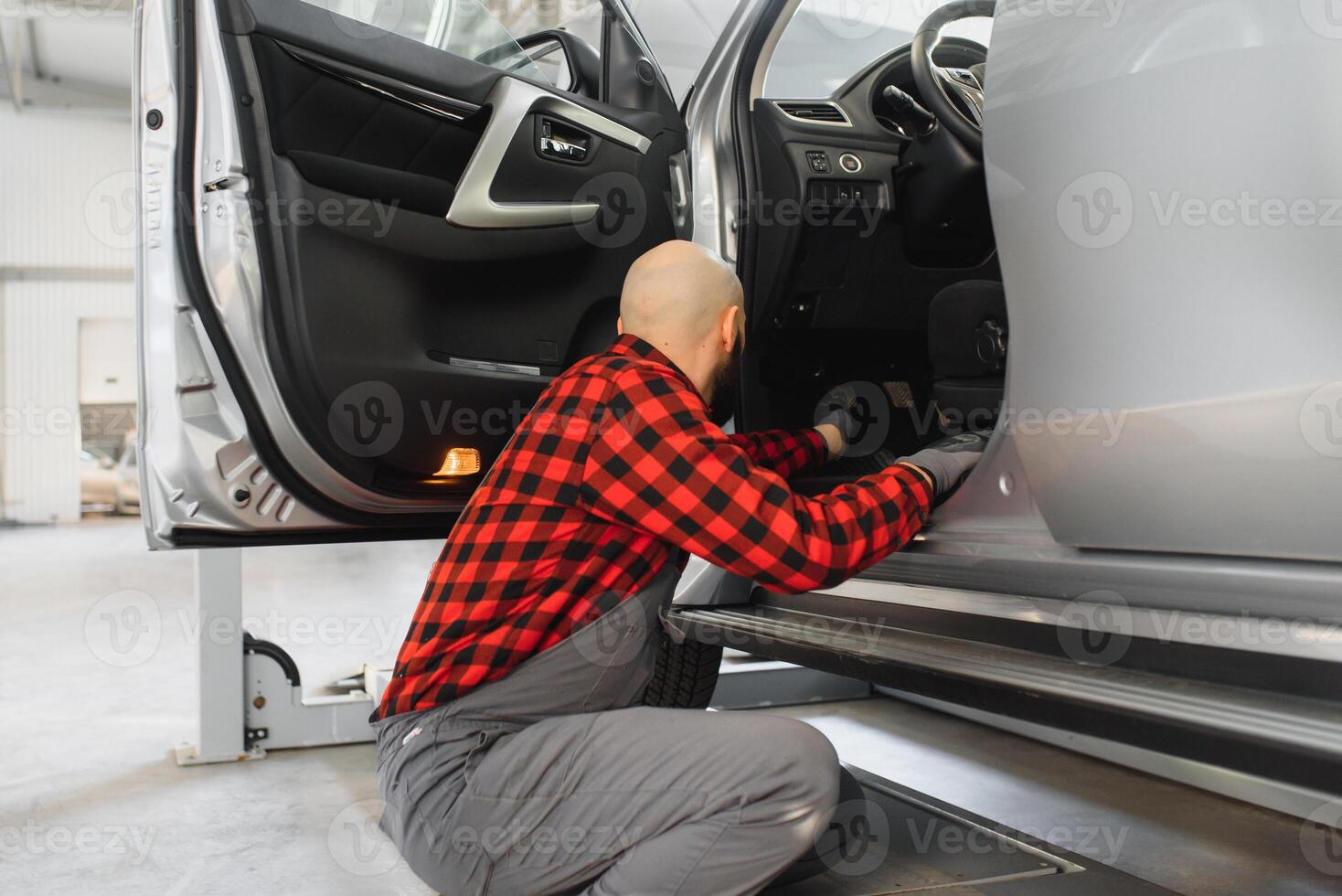mecánico trabajando y participación llave inglesa de Servicio orden para mantener coche a el reparar tienda foto
