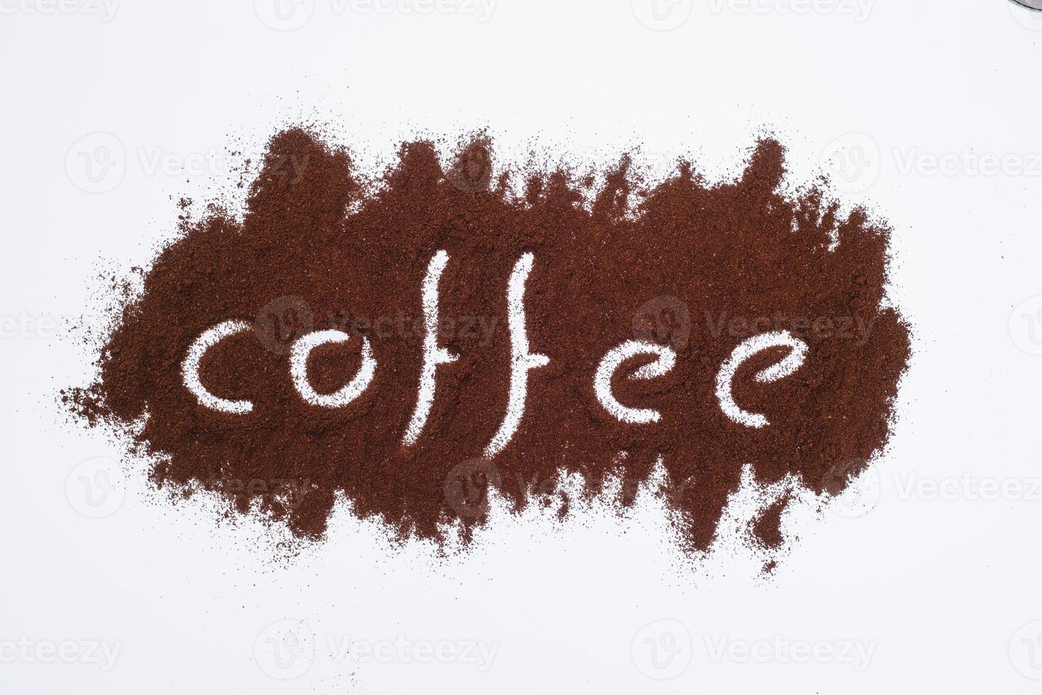 Coffee word written on ground coffee layer, white background photo