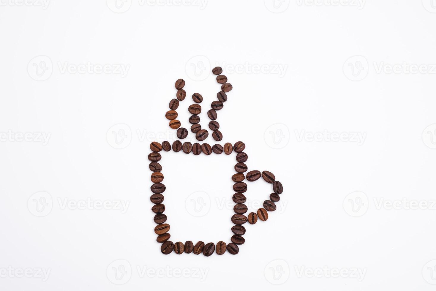 Coffee cup with foam made from coffee beans isolated on white photo