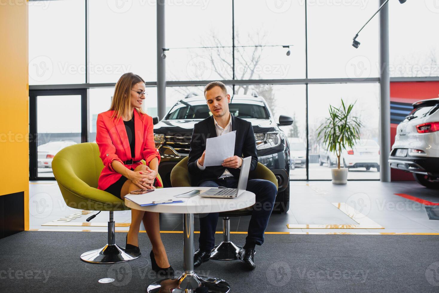 business woman buys a car at a car dealership. Concept of happy business people photo