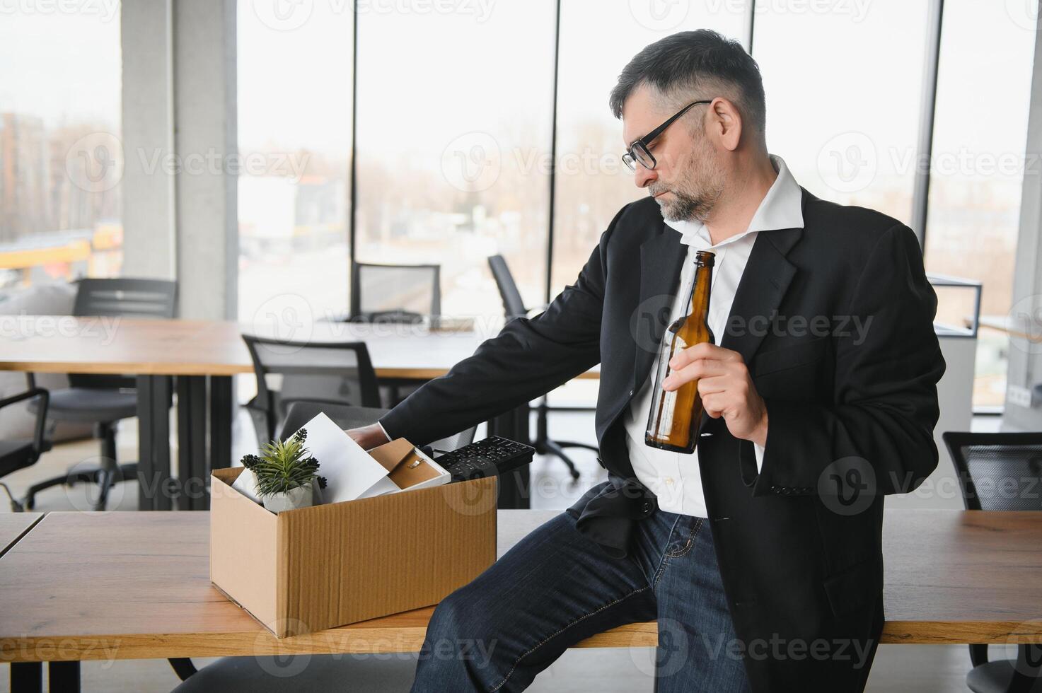 Old alcohol addicted male employee in dismissal concept photo