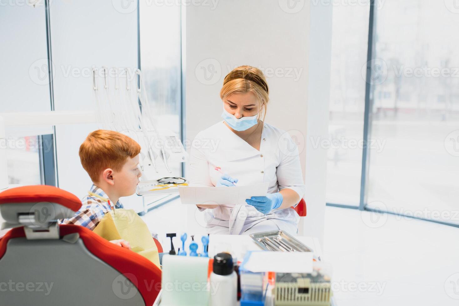 Female dentist and child in a dentist office photo