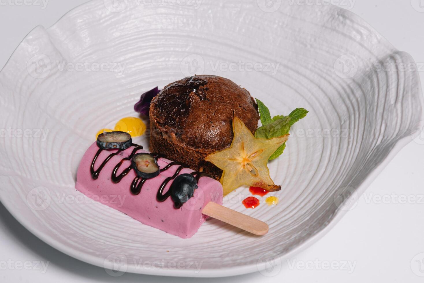 Chocolate fondant with vanilla ice cream and raspberry sauce. photo