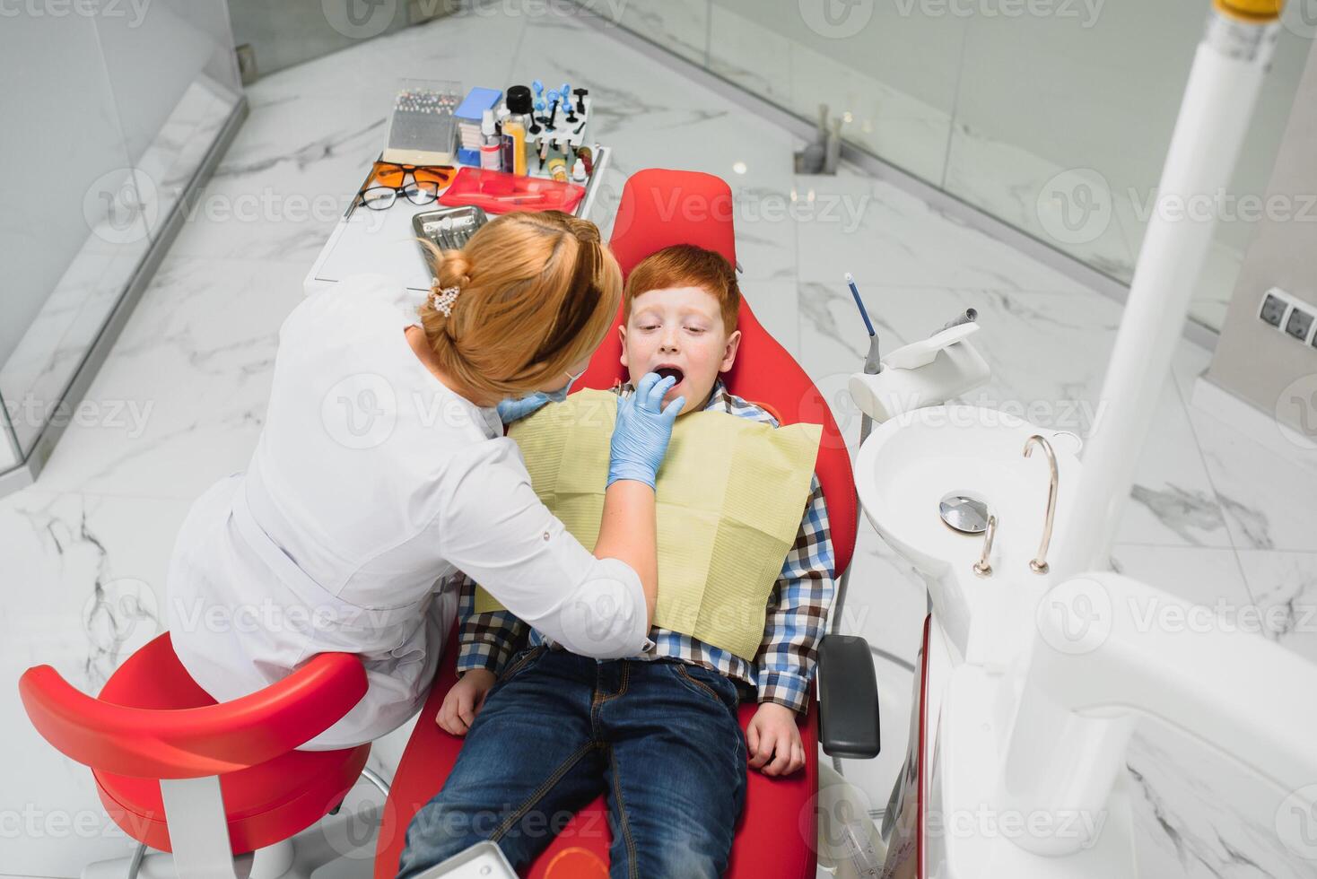 Boy satisfied with the service in the dental office. concept of pediatric dental treatment photo