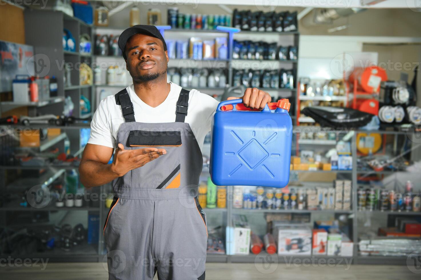 Portrait of a handsome african salesman in an auto parts store. The concept of car repair photo