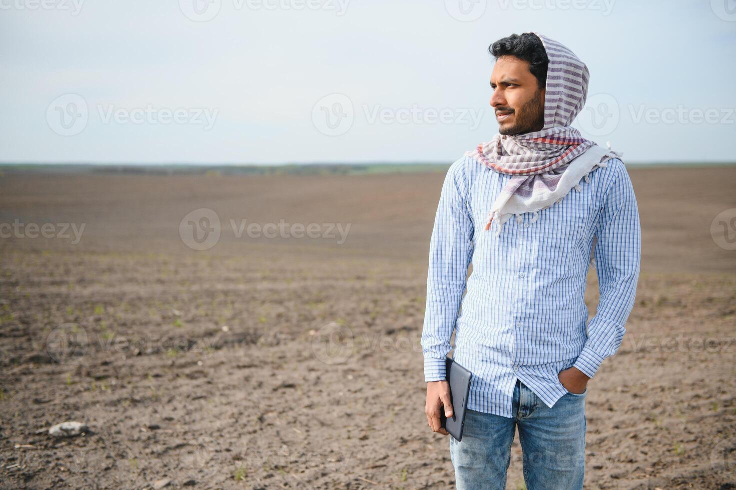 Young indian farmer at agriculture field. photo